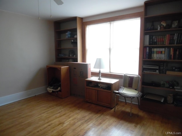 sitting room featuring ceiling fan and wood-type flooring