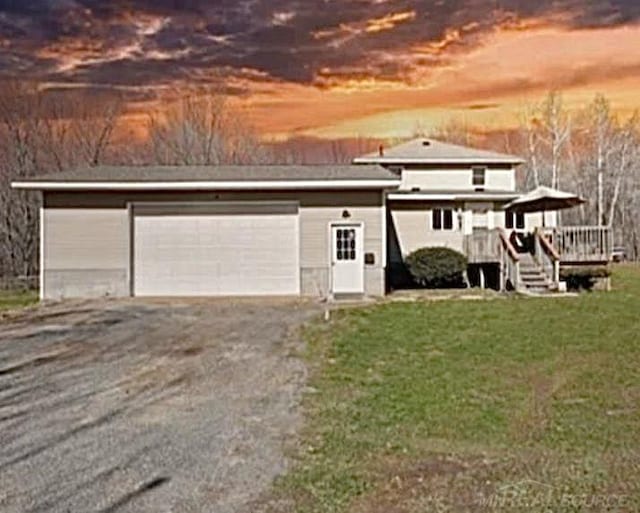 view of front of house with a lawn and a garage