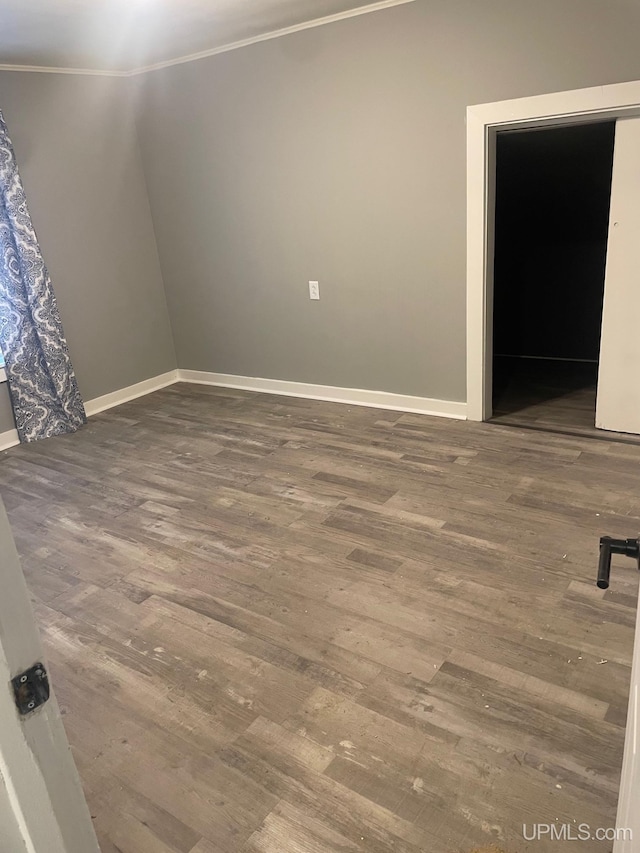 unfurnished room featuring crown molding and hardwood / wood-style floors