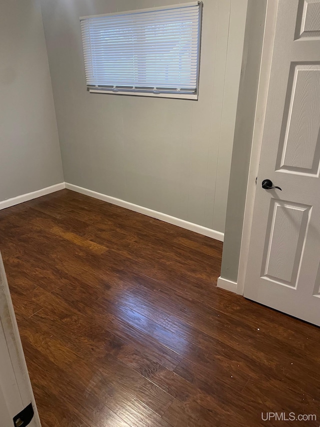 spare room with dark hardwood / wood-style floors