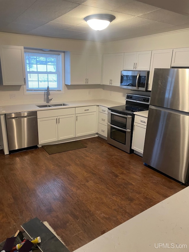 kitchen with white cabinets, dark hardwood / wood-style flooring, sink, and stainless steel appliances