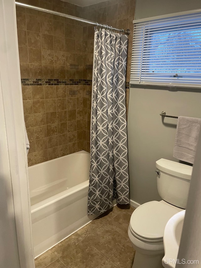 bathroom with tile patterned floors, shower / bath combo, and toilet