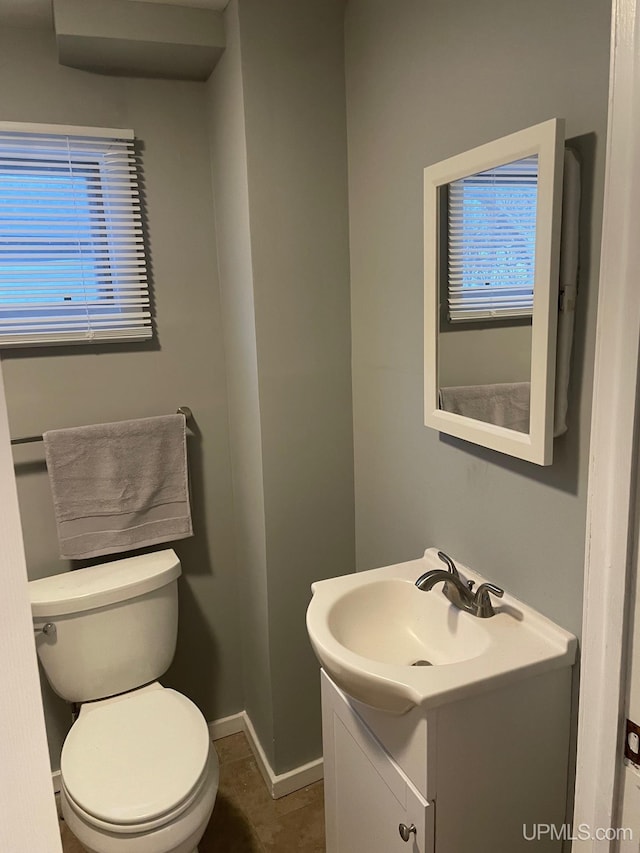 bathroom with tile patterned floors, vanity, and toilet