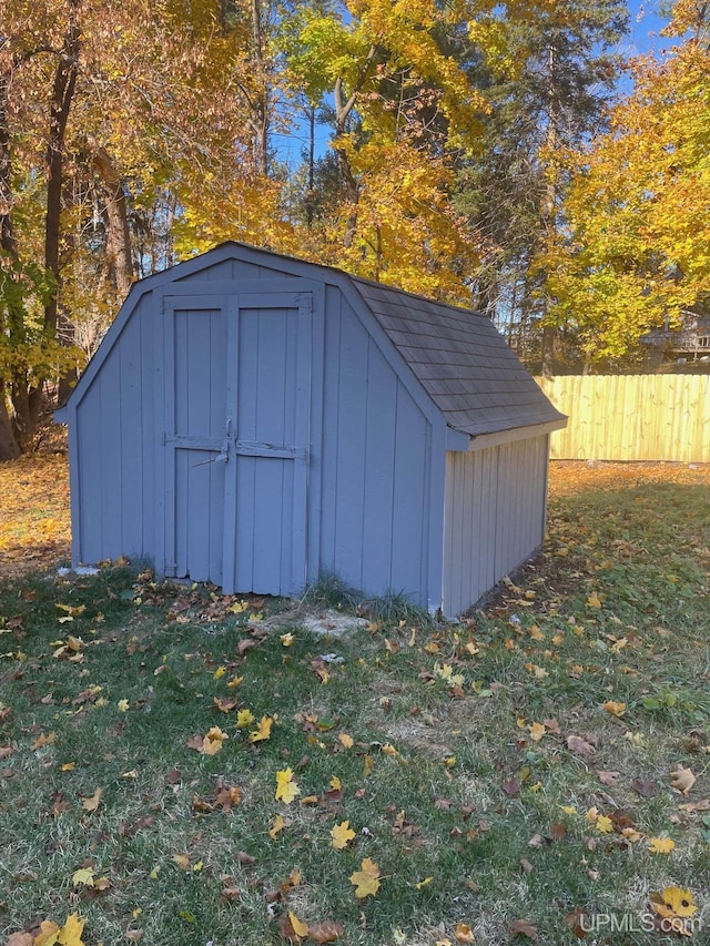 view of outbuilding with a yard