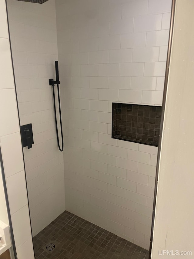 bathroom with a tile shower