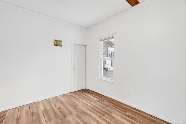 spare room featuring light hardwood / wood-style floors and ornamental molding