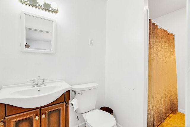 bathroom with tile patterned floors, vanity, and toilet