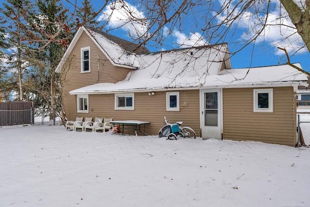 view of snow covered rear of property