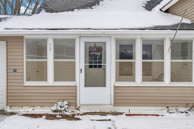 view of snow covered property entrance