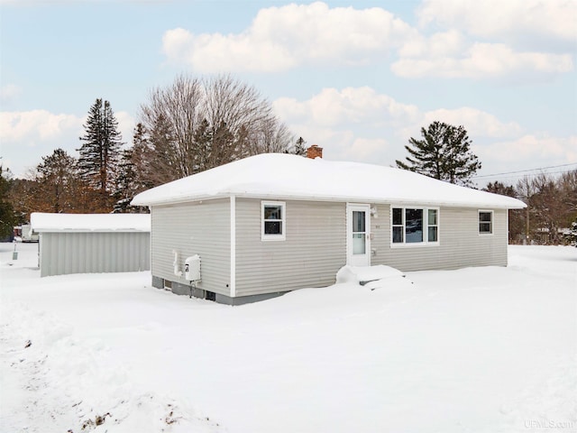 view of snow covered rear of property