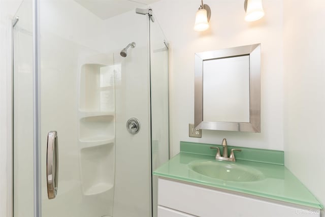 bathroom featuring a stall shower and vanity