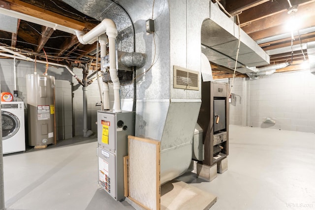 utilities featuring washer / clothes dryer, water heater, and visible vents