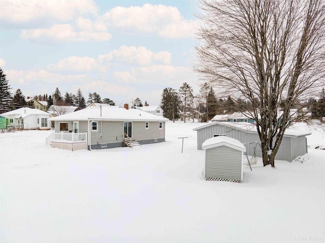 snow covered property with a deck