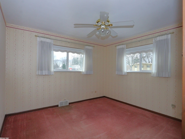 unfurnished room featuring carpet flooring, crown molding, ceiling fan, and a healthy amount of sunlight