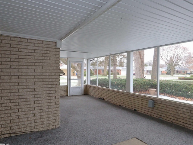 unfurnished sunroom with a healthy amount of sunlight and lofted ceiling