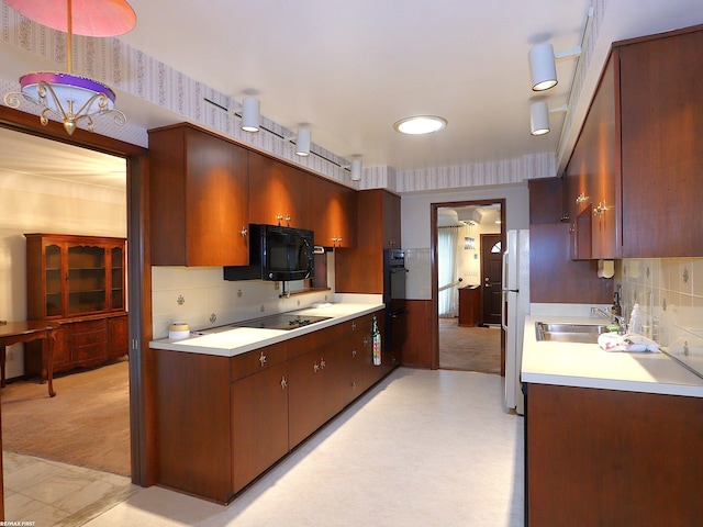 kitchen with sink, light colored carpet, backsplash, and black appliances