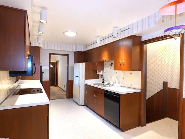 kitchen featuring black appliances, light colored carpet, sink, and tasteful backsplash