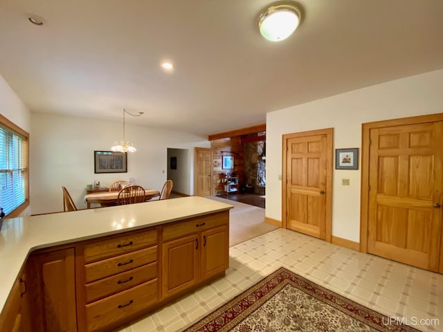N10006 Shore Dr, Au Train, MI 49806 - kitchen with kitchen peninsula, light carpet, sink, white electric range, and hanging light fixtures