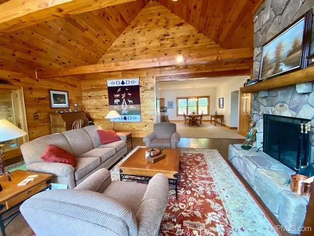 living room featuring high vaulted ceiling, wood walls, wood-type flooring, a fireplace, and wood ceiling