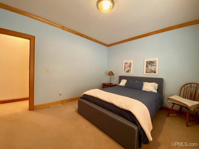 bedroom with carpet floors and ornamental molding