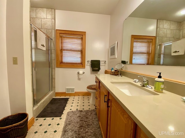 bathroom featuring vanity, toilet, and walk in shower