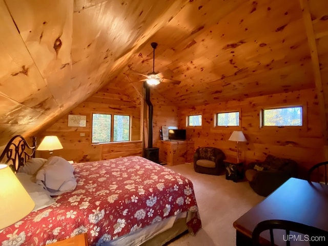 carpeted bedroom with vaulted ceiling, wood ceiling, and wood walls