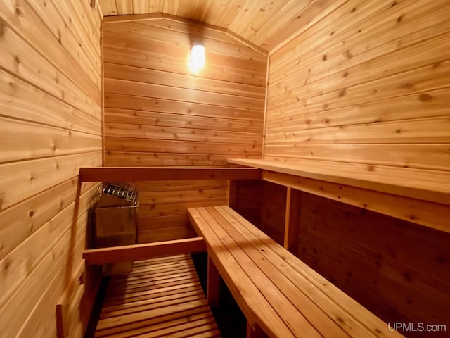 N10006 Shore Dr, Au Train, MI 49806 - sitting room with a wood stove, wooden walls, carpet, and vaulted ceiling