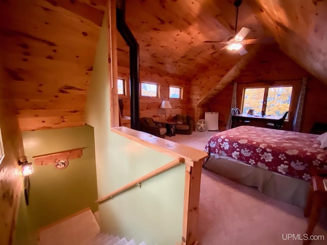 bedroom with carpet floors, vaulted ceiling, ceiling fan, and wooden ceiling