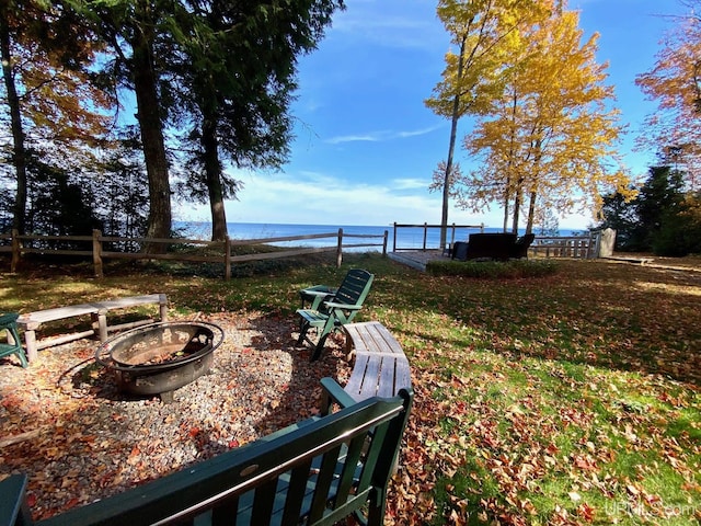 view of yard featuring a fire pit and a water view