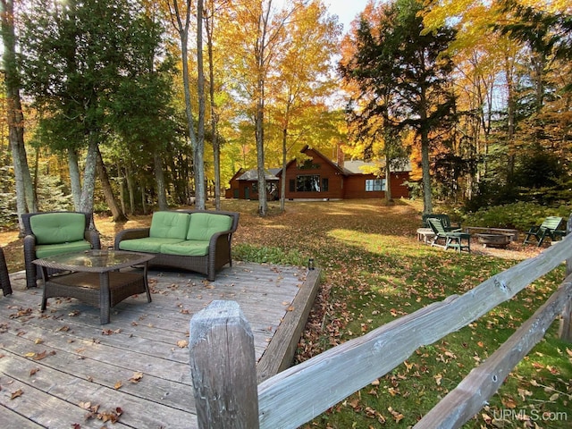 wooden deck with a lawn and an outdoor living space