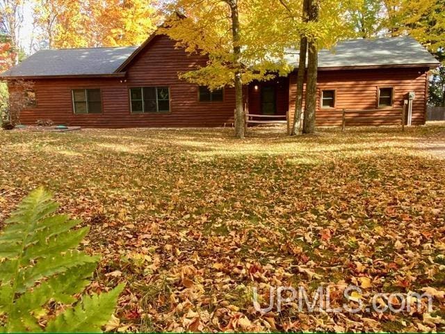 rear view of property with a yard