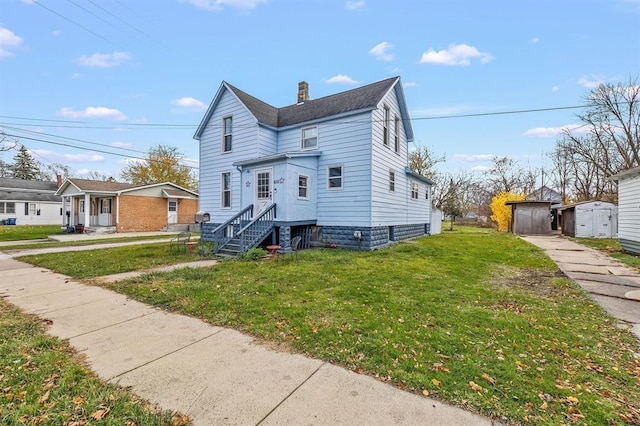 view of front of house with a front lawn and a storage unit