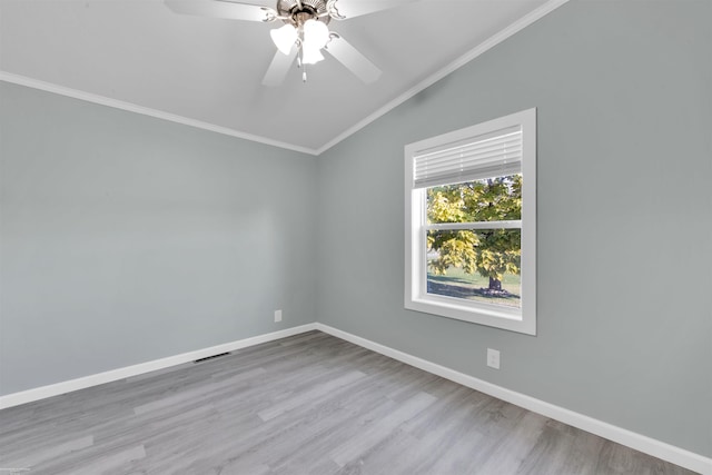 unfurnished room featuring ceiling fan, light hardwood / wood-style flooring, crown molding, and vaulted ceiling