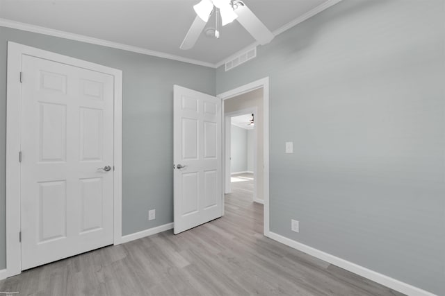 unfurnished bedroom featuring ceiling fan, light hardwood / wood-style flooring, and crown molding