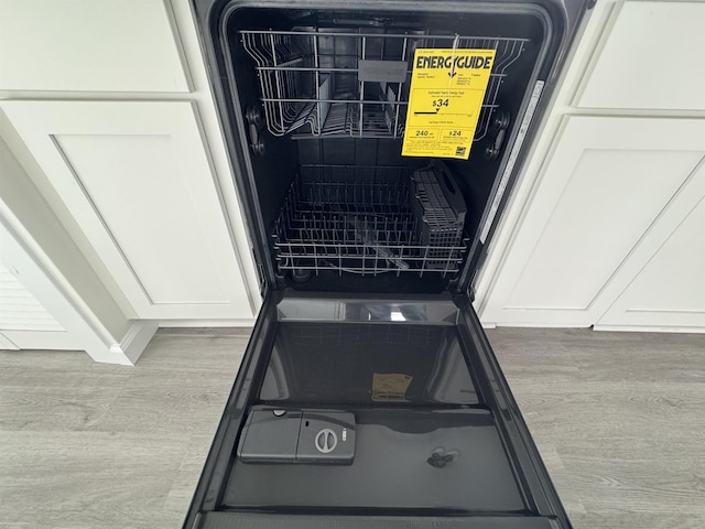 interior details featuring dishwasher and white cabinetry