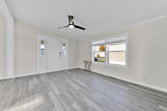 interior space featuring vaulted ceiling, light hardwood / wood-style flooring, ceiling fan, and crown molding