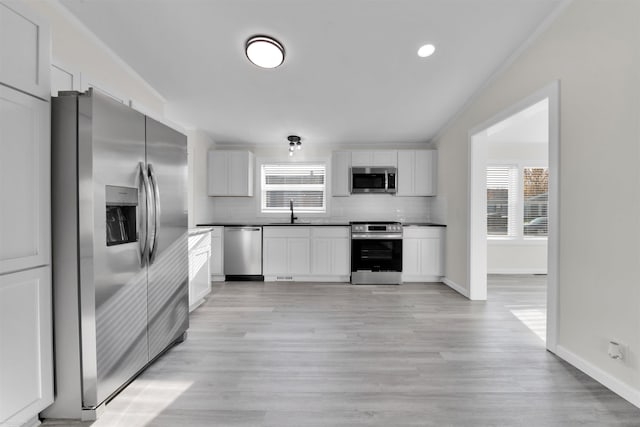 kitchen with white cabinetry, sink, a healthy amount of sunlight, and appliances with stainless steel finishes