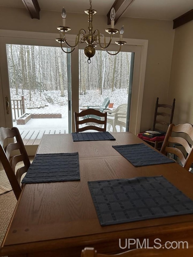 dining room with beam ceiling and a notable chandelier