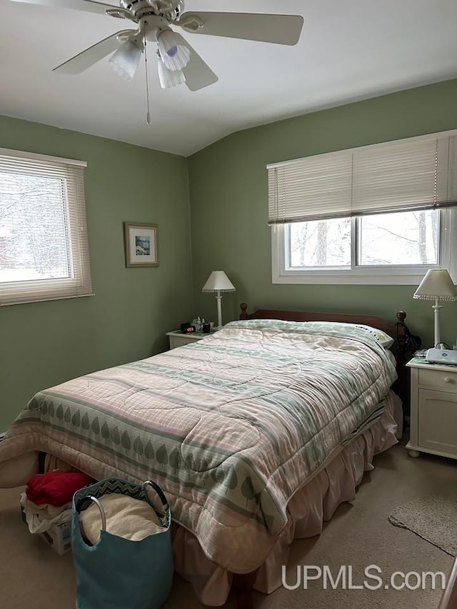 bedroom featuring ceiling fan and light colored carpet