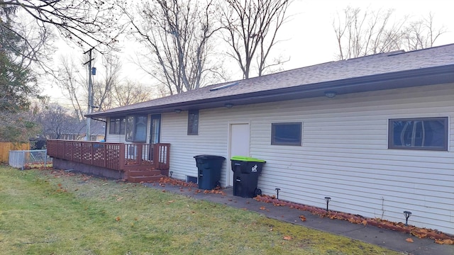 view of home's exterior with a yard and a wooden deck