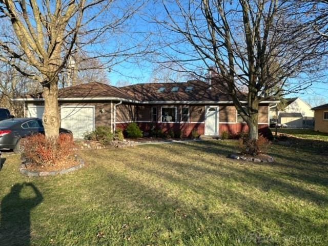 single story home with a front yard and a garage