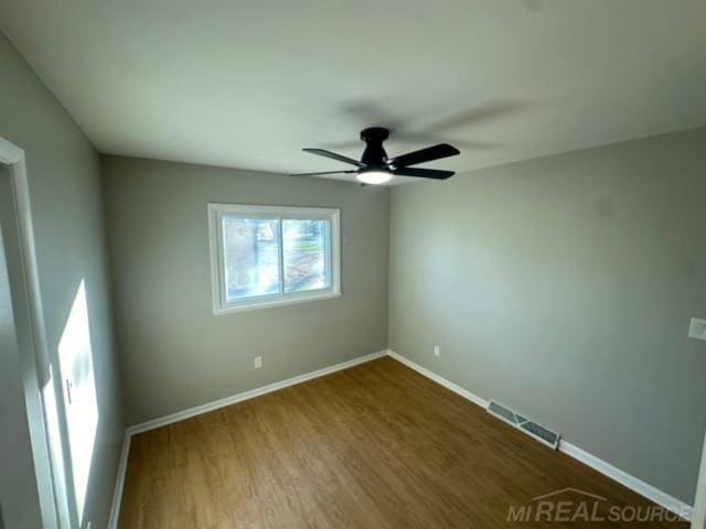 empty room with ceiling fan and wood-type flooring