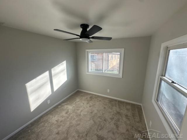 unfurnished room featuring light carpet and ceiling fan