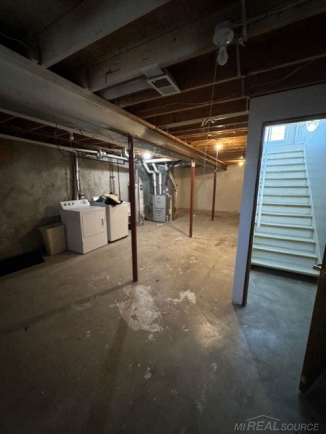 basement with separate washer and dryer and heating unit