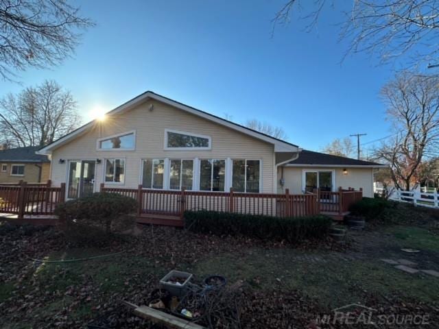 back of house featuring a wooden deck