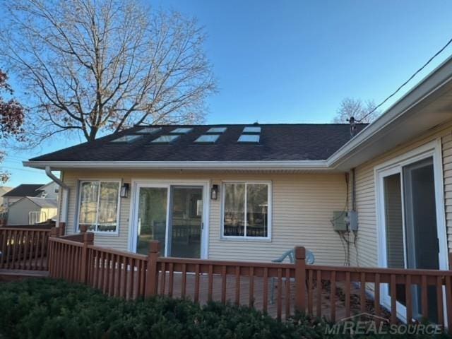 back of house featuring a deck