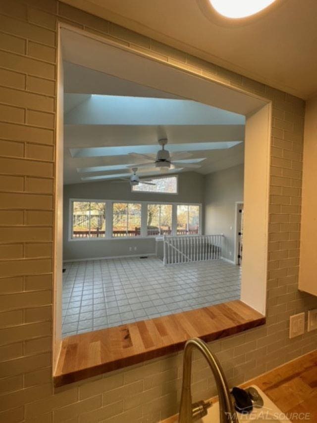 interior space with ceiling fan and lofted ceiling