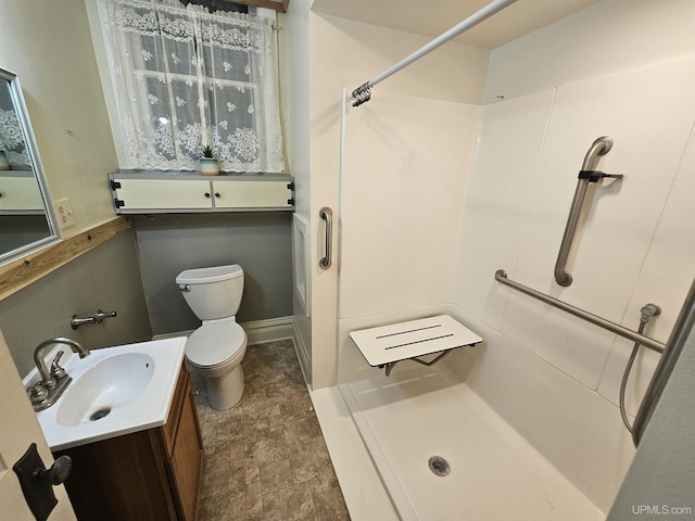 bathroom with a shower, vanity, and toilet