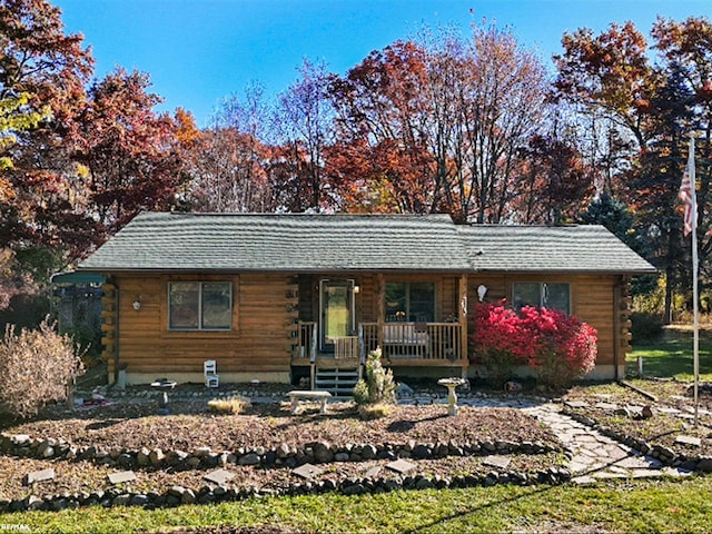 log-style house featuring a porch