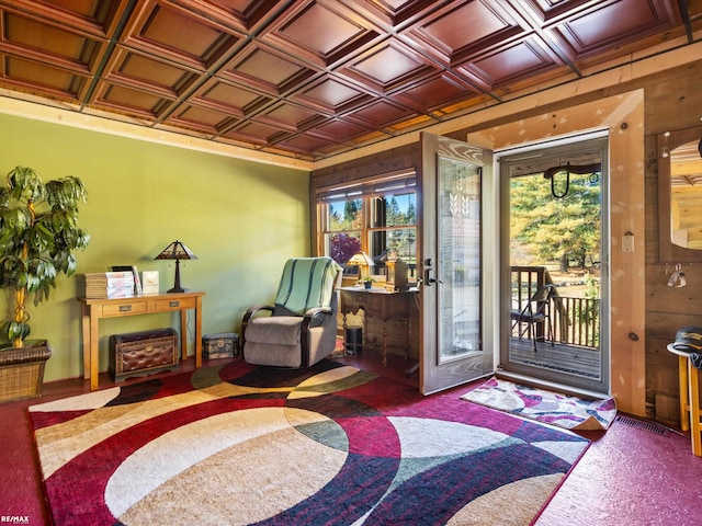 foyer entrance featuring wood walls, plenty of natural light, and coffered ceiling